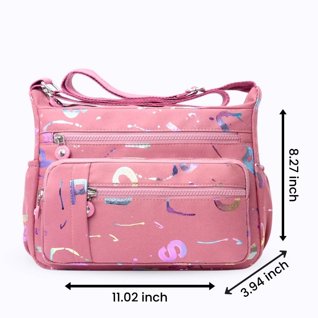 Large stylish crossbody alphabet bag in pink with multicolor letter prints and multiple zip compartments, ideal for fashion-forward versatility.