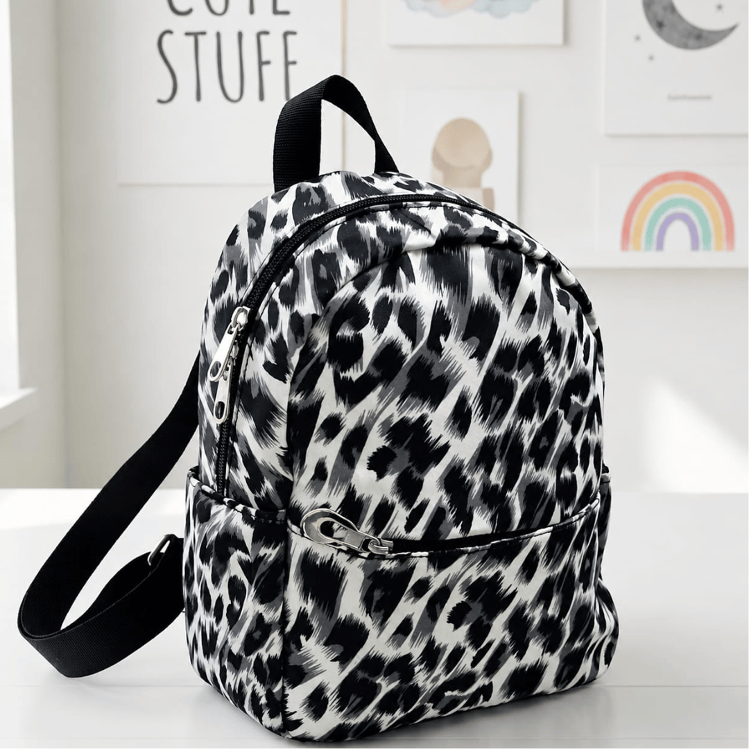 Multicolor small Backpack perfect for travel Leopard print backpack on a white surface