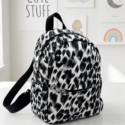 Multicolor small Backpack perfect for travel Leopard print backpack on a white surface