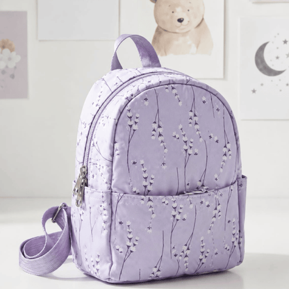 Multicolor small Backpack perfect for travel with floral pattern on a light background