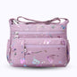 Large stylish crossbody alphabet bag in lavender with multicolor letter print, featuring multiple zippered compartments for fashion and versatility.
