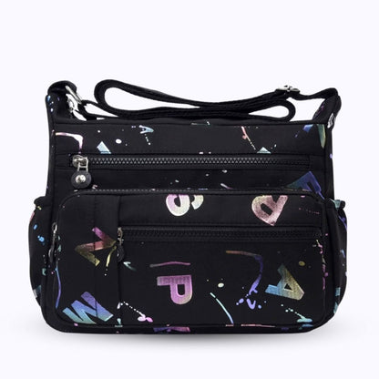 Large stylish crossbody alphabet bag in black with colorful letter print, featuring multiple zippered compartments for fashion and versatility.