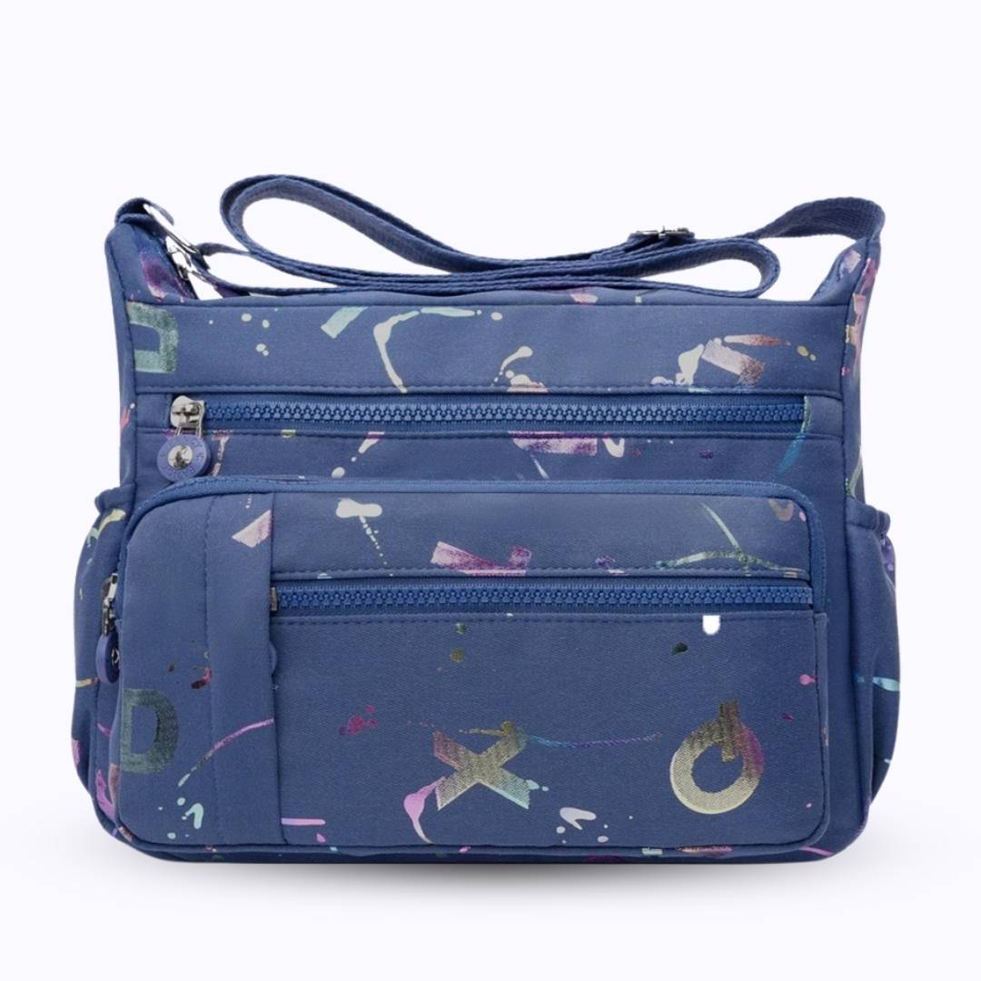 Large stylish crossbody alphabet bag in navy blue with multicolor letter prints and multiple zippered compartments for fashion and versatility.