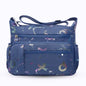 Large stylish crossbody alphabet bag in navy blue with multicolor letter prints and multiple zippered compartments for fashion and versatility.