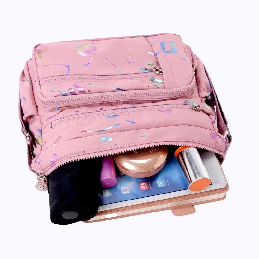 Large stylish crossbody alphabet bag in pink with multicolor letter prints and multiple zip compartments, ideal for fashion-forward versatility.