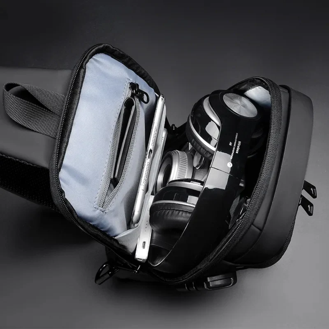 Black sling bag with compartments containing electronic 
